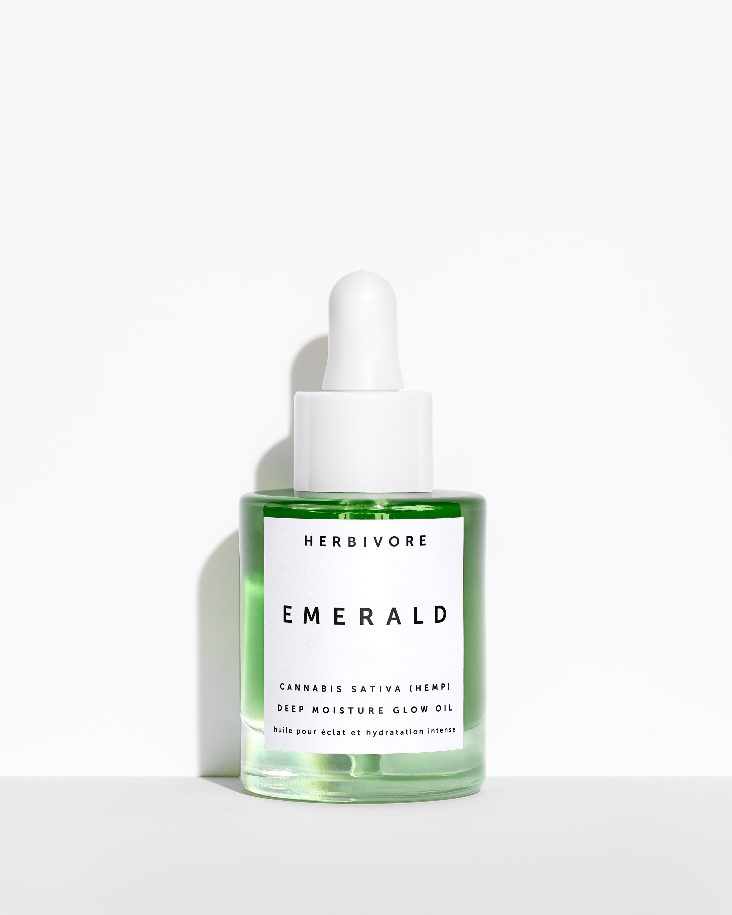 Bottle of Emerald Hemp Seed Face Oil against a white background | Herbivore Botanicals